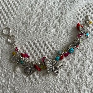 Silver charm bracelet with colored beads and silver with black charms